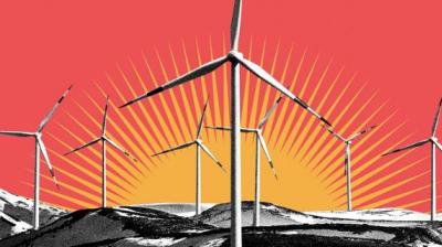 Wind turbines on a red background with mountains in the background.