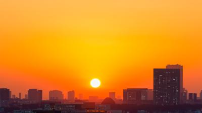 The sun is setting over a city.