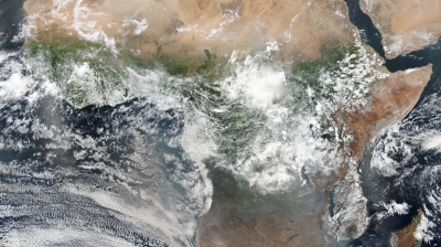 A satellite image of the African continent, showing diverse landscapes including deserts in the north, dense forests in central areas, and surrounding oceans.